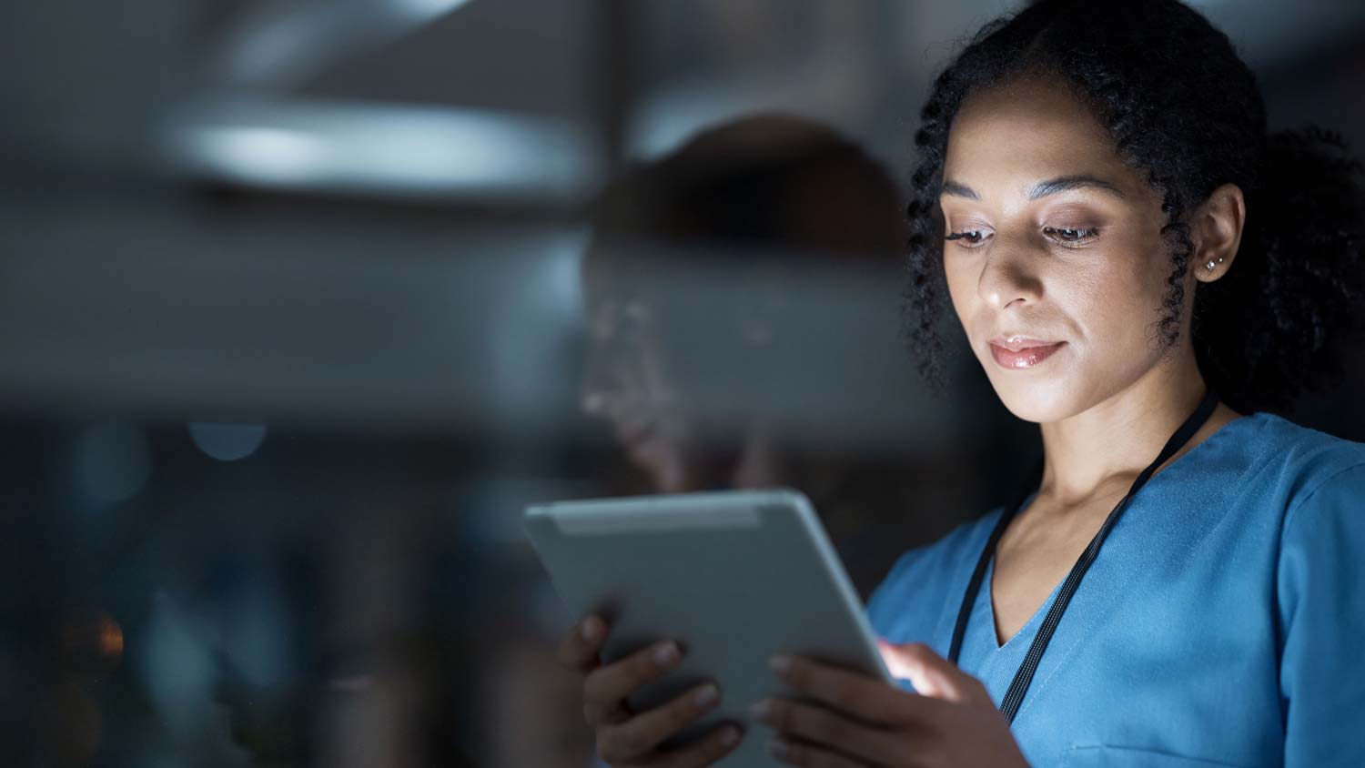 Nurse looking at data on tablet
