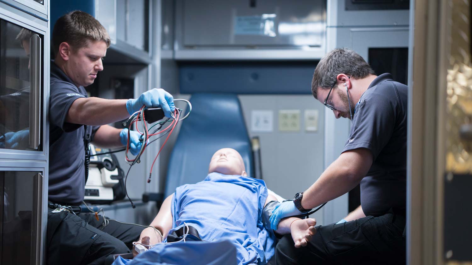 Nurses in ambulance with simulated patient