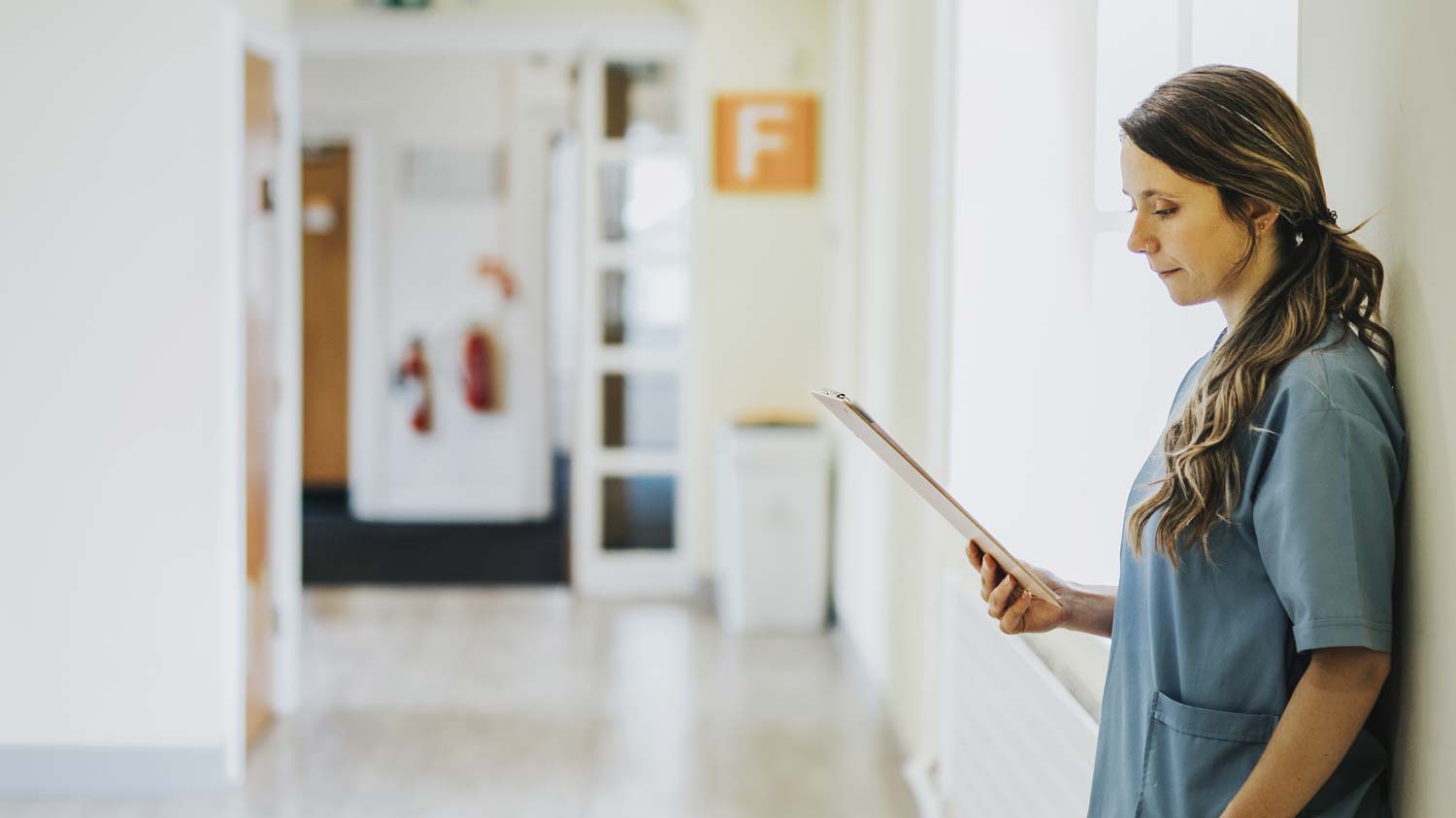 Nurse reading patient tables