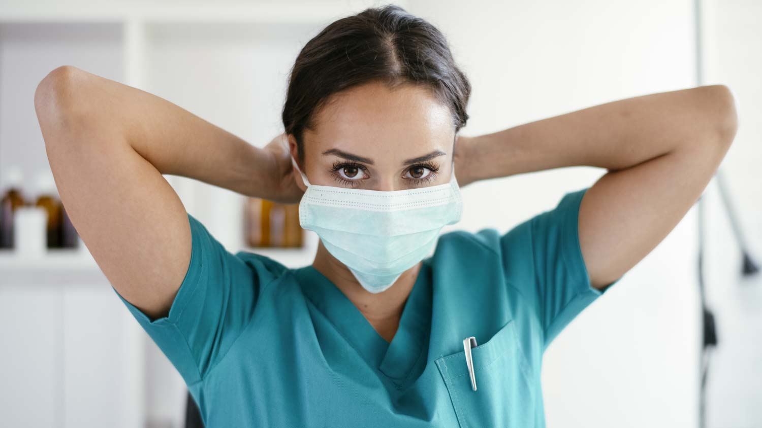 Nurse putting on medical face mask