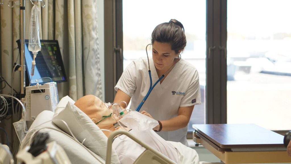 Nursing student running tests on dummy patient